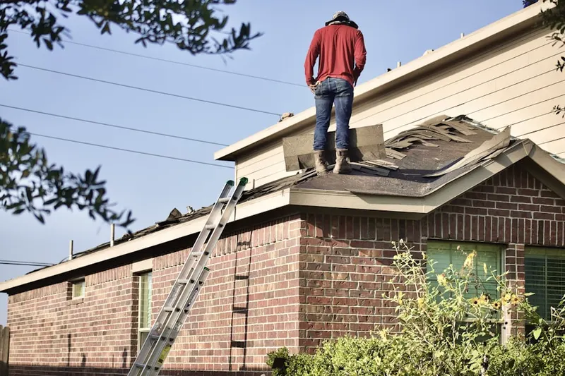 Professional roofer working on a residential roof in Patriot Village